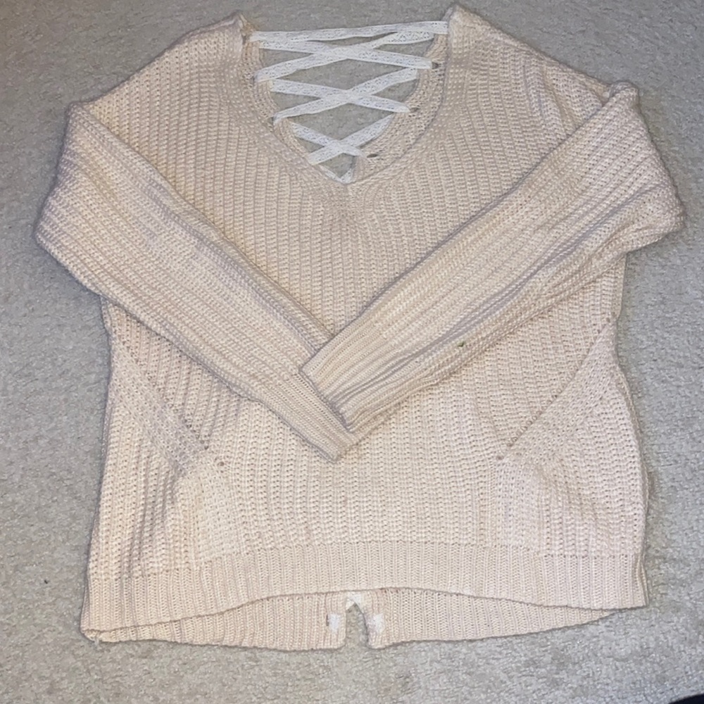 Pale pink oversized chunky knit sweater with lace up back